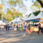 Blurred,Image,Of,People,In,Day,Market,Festival,In,City