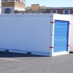 Two,White,Storage,Pods,With,Blue,Doors,On,A,Asphalt