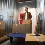 Man,Pushing,Cart,Inside,Storage,Unit