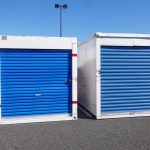 Two,White,Storage,Pod,Containers,With,A,Blue,Door,On